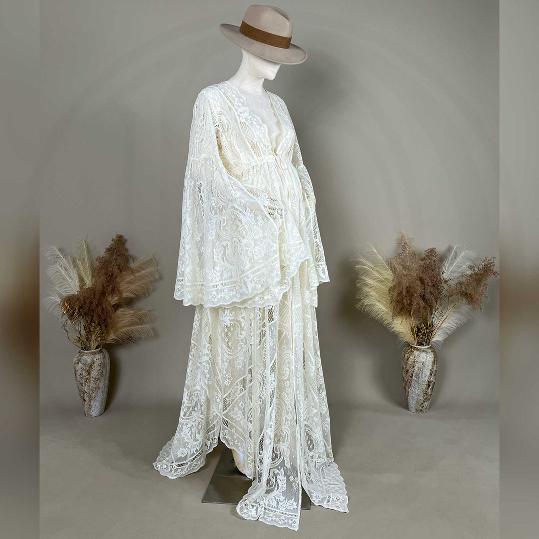A beige lace ,Abrota dress with long bell sleeves and a V-neckline, displayed on a mannequin. 