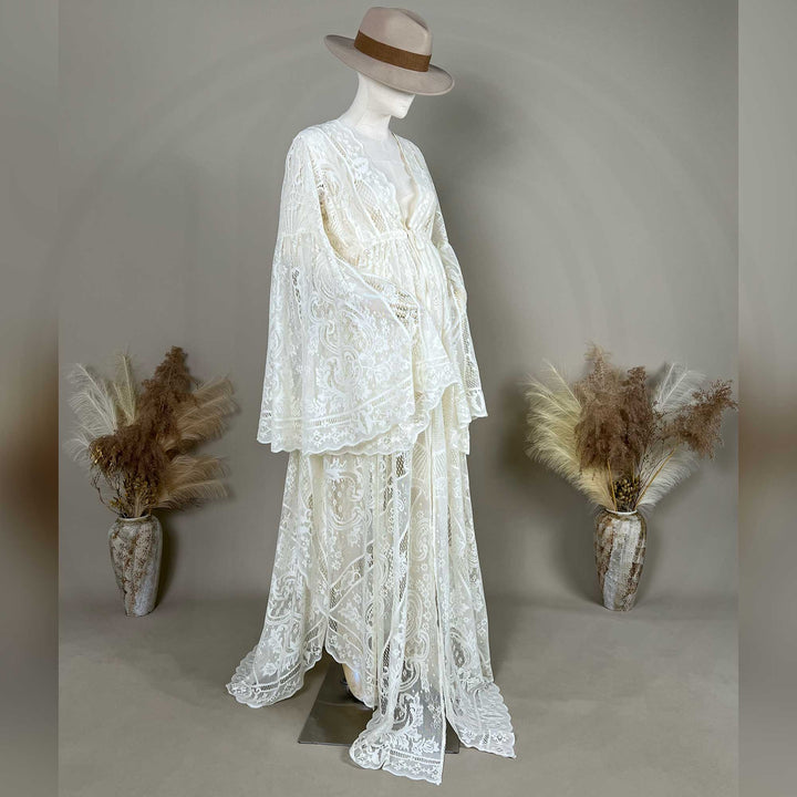 A beige lace ,Abrota dress with long bell sleeves and a V-neckline, displayed on a mannequin. 