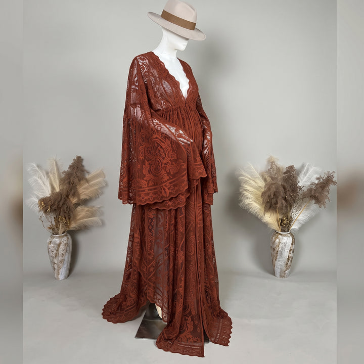 A terracotta lace ,Abrota dress with long bell sleeves and a V-neckline, displayed on a mannequin.