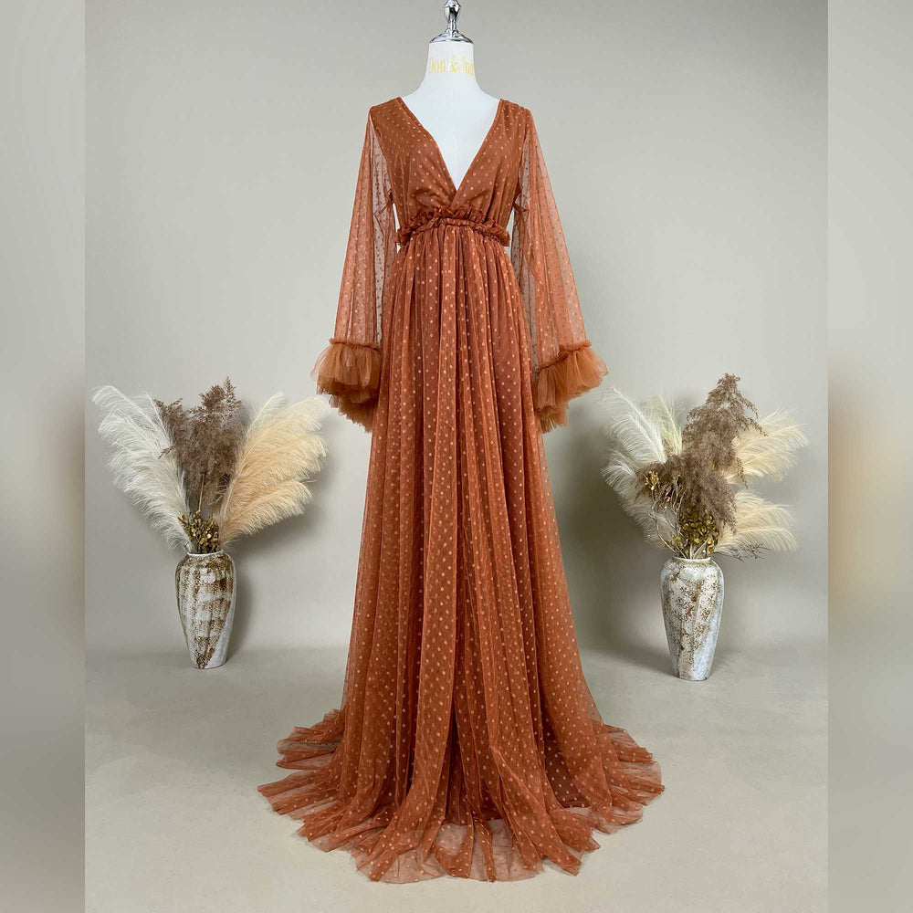 Alectrona terracotta polka dot tulle long sleeved maternity photography dress displayed on a mannequin.