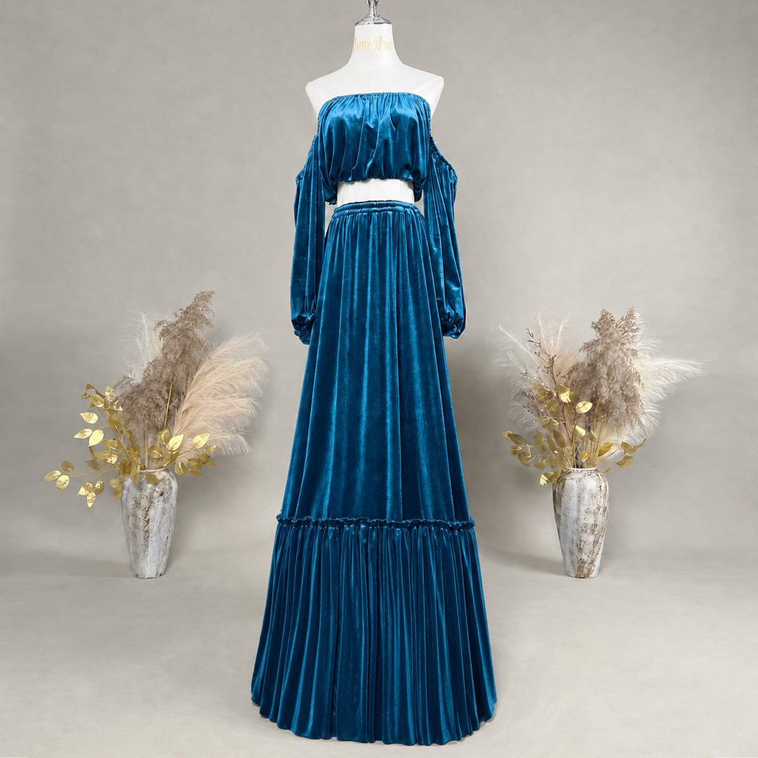 A KO-17,a Belisama velvet off-shoulder top and floor-length skirt are displayed on a mannequin. The two-piece outfit has a ruffled skirt hem.