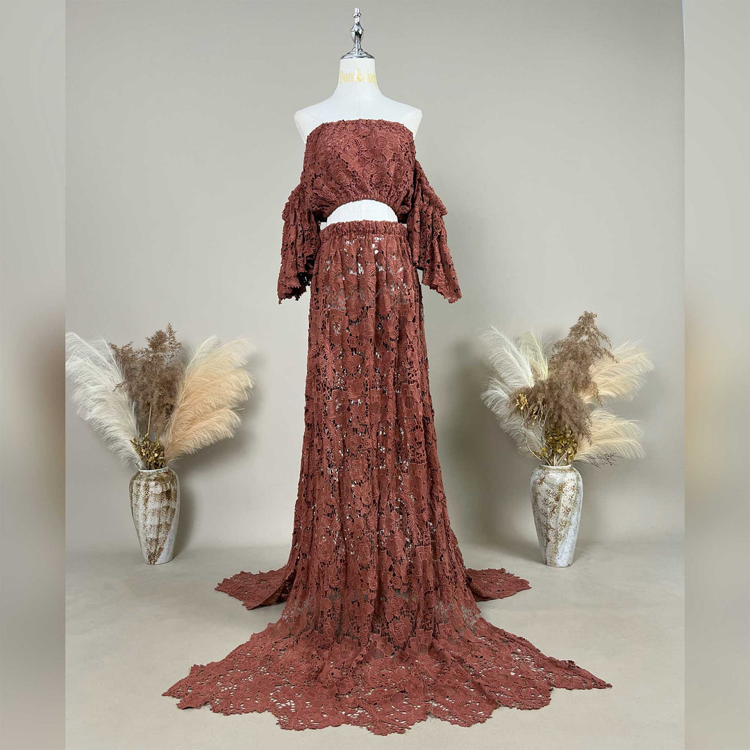 A terracotta two-piece lace maternity photography set displayed on a mannequin, featuring an off-the-shoulder ruffled crop top and a high-waisted floor-length skirt with a sweeping train