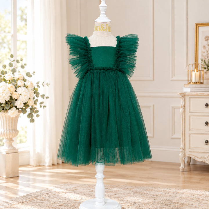 A Callisto green tulle dress on a mannequin with tulle ruffled shoulders