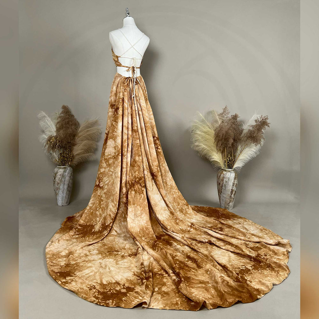 A back view of Demeter tie dye printed spaghetti straps two-piece gown with a deep V-neck and train is displayed on a mannequin. 