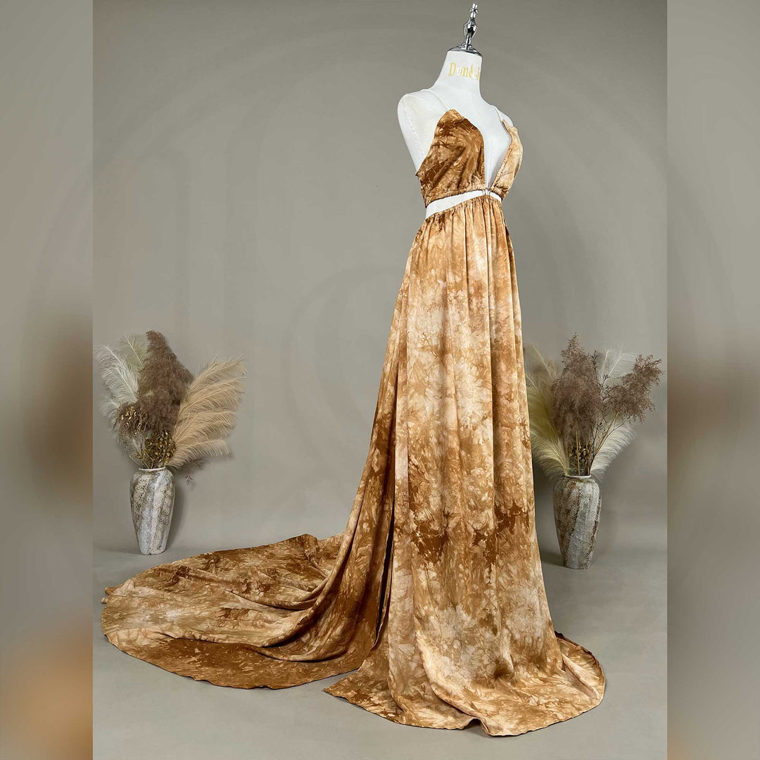 A side view of Demeter tie dye printed spaghetti straps two-piece gown with a deep V-neck and train is displayed on a mannequin. 