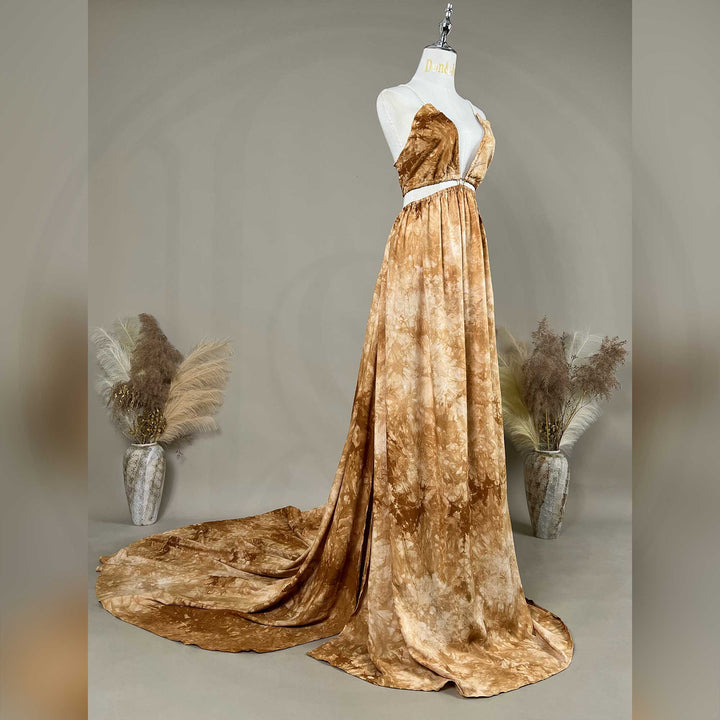 A side view of Demeter tie dye printed spaghetti straps two-piece gown with a deep V-neck and train is displayed on a mannequin. 