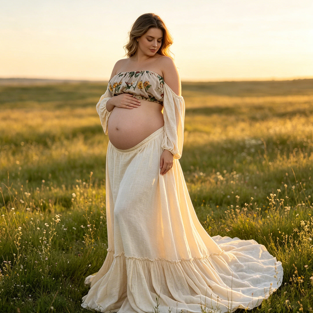 A pregnant woman stands in a grassy field wearing a beige boho embroidery floral two-piece set gown, holding her belly.
