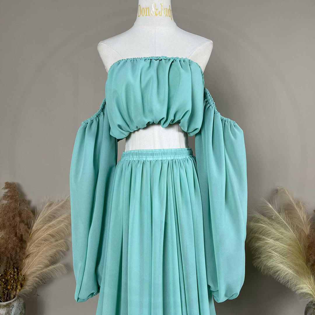 A gaia mint flowy chiffon off-shoulder maternity top with long sleeves displayed on a mannequin.