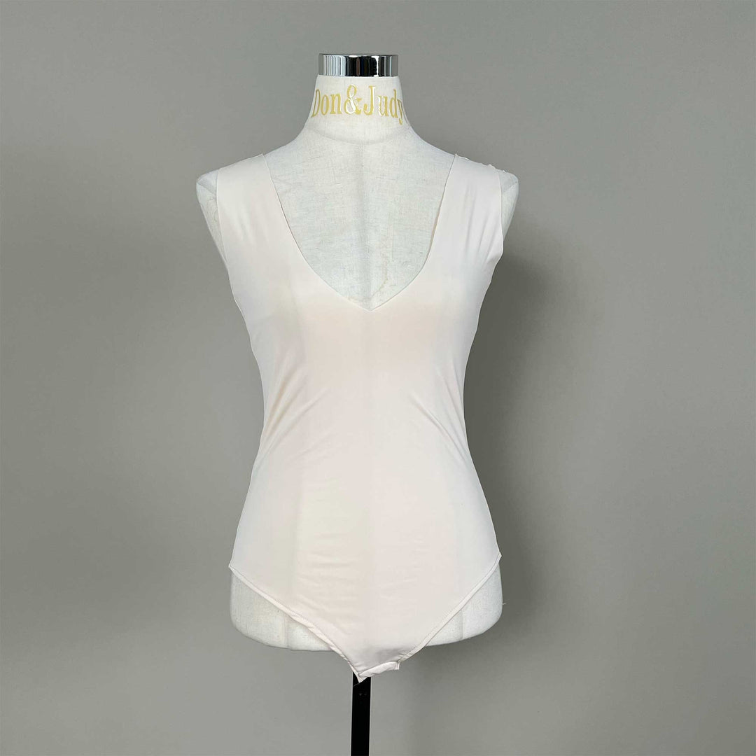 A mannequin displays a skin sleeveless V-neck bodysuit with a high-cut hem.