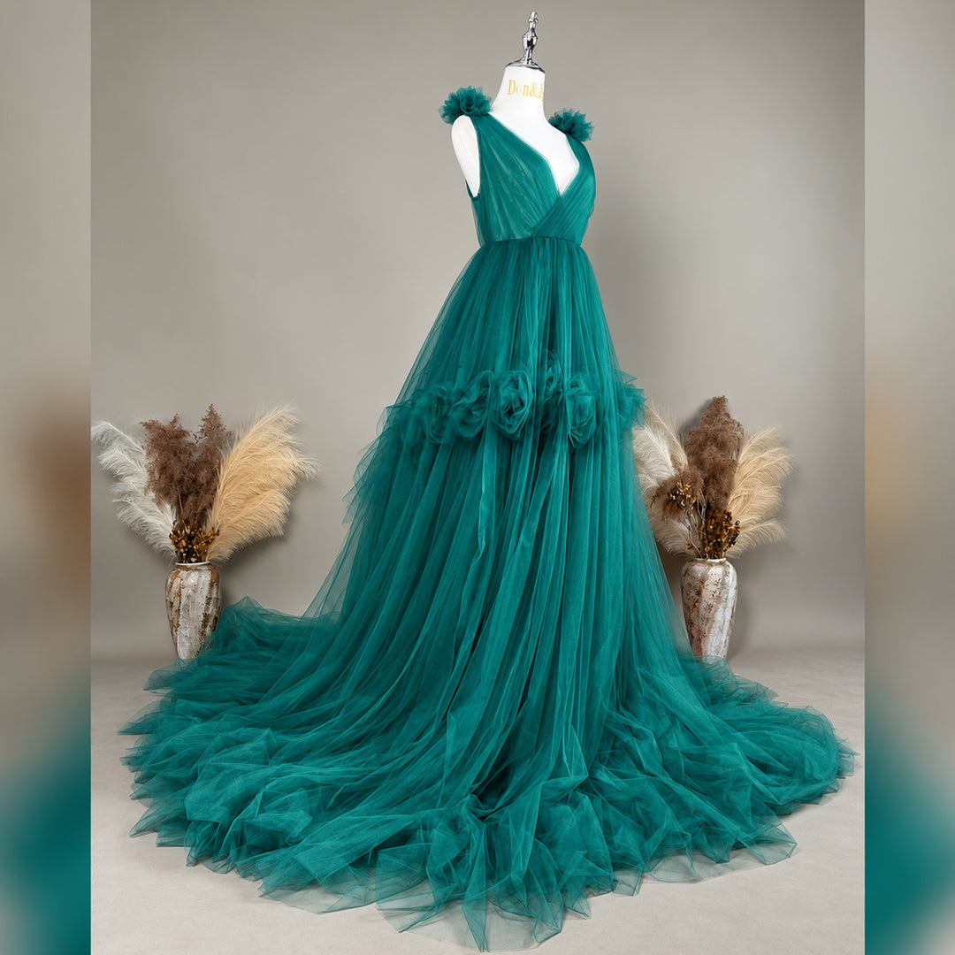 A Mila Color 13 tulle gown is displayed on a mannequin with floral details on the shoulders, waist, and neckline. 