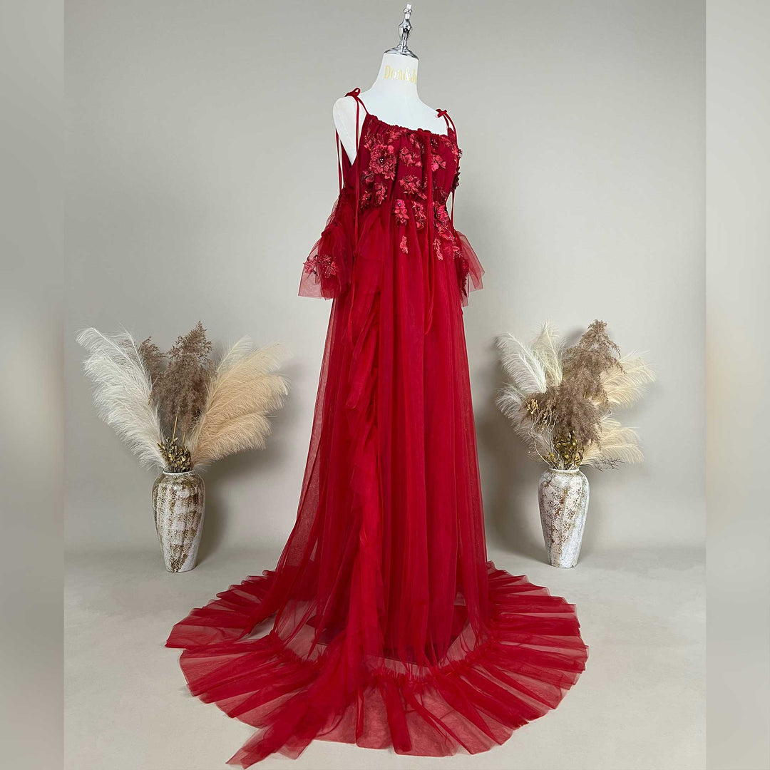 Side view of a pregnant woman wearing a Oreades red floral embroidered off-shoulder tiered ruffle maternity photography dress