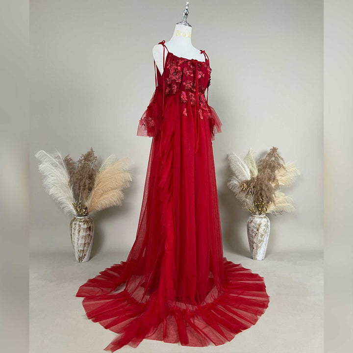 Side view of a pregnant woman wearing a Oreades red floral embroidered off-shoulder tiered ruffle maternity photography dress